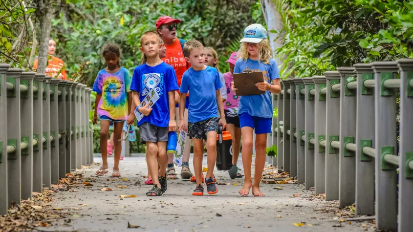kids walking down boardwalk