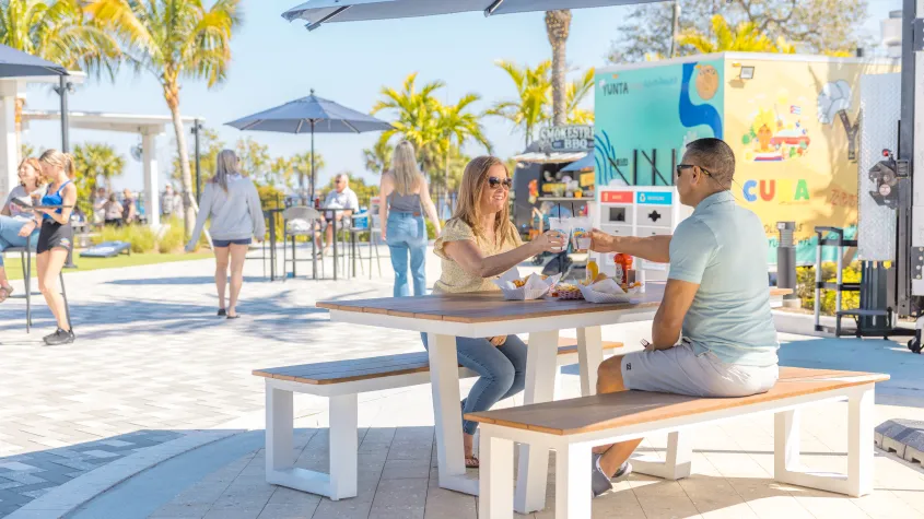 Couple dining at table under umbrella