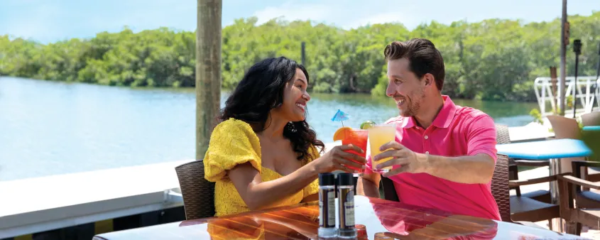 A couple enjoys dining at a waterfront restaurant